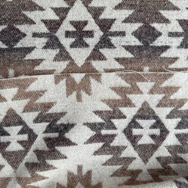 Närbild av Aspen som visar det geometriska mönstret och de naturliga färgerna i beige, brun och naturvitt.