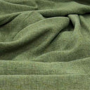 Närbild av gardintyget Katja i grön färg, dubbelbredd 300 cm i polyester med mjuk struktur för gardiner.