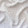 Närbild på Sophia gardintyg i 100 % polyester med mjuk struktur, vackert fall och ljusbeige ton.