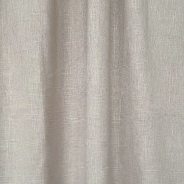 Beige gardintyg “Göran” i slow motion som rör sig mjukt i ljuset och visar tygstruktur, fall och naturlig textur.